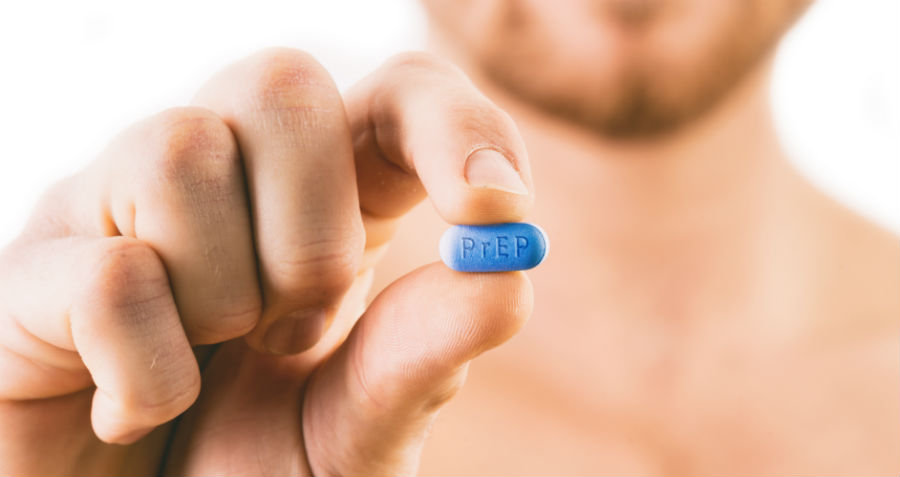 A man holds a PrEP Truvada tablet